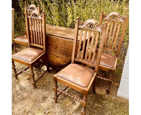 A set of four 20th century oak dining chairs, in a 18th century manner, scrolling crest rail back with sphere finial, stuffed