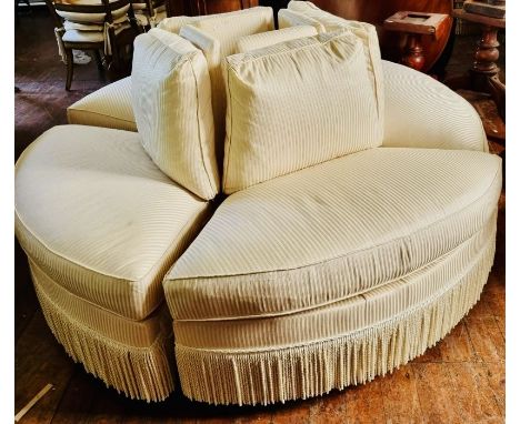 An American Councill four seated conversation sofa, upholstered back and seat, raised on castors.&nbsp;