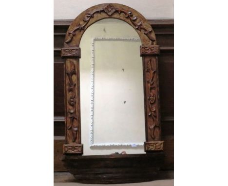A large arch shaped mirror in a decorative wooden frame , 104cm x 54.5cm