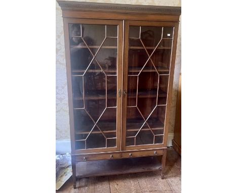 A Chippendale influenced mahogany standing bookcase, dental cornice above two astragal glazed doors, enclosing four adjustabl