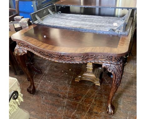A Chippendale style crossbanded mahogany extending dining table, cartouche shaped top, carved frieze raised on cabriole legs.