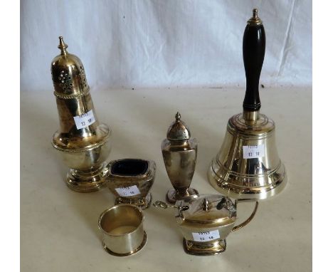 A group of silver plate , to include a bell with turned wood handle a sugar sifter , a napkin ring and a cruet set