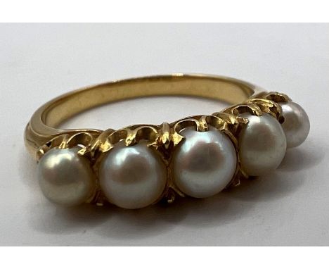 A 19th century half hoop pearl set ring. Testing as 18 carat gold with five whole pearls claw set into the piece. Gross weigh