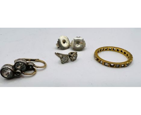 A pair of 18ct gold studs set with colourless cubic zirconia stones, along with a pair of 925 silver backs; plus a yellow met
