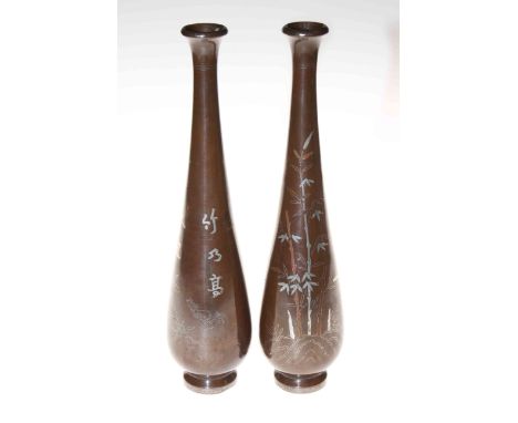 A pair of Japanese bronze vases inlaid with silver and gold bamboo, cockerels and inscriptions, 29cm.
