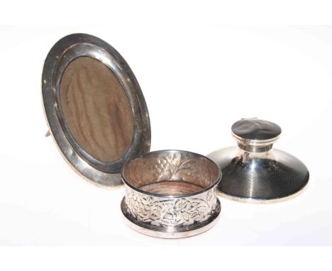 Silver capstan inkwell, silver photograph frame and plated bottle coaster (3).