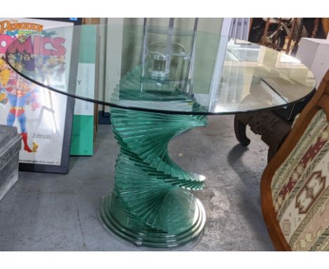 A vintage contemporary circular glass topped dining table having a spiral stepped base 71cm h x 104.5cm wLocation: GIf there 