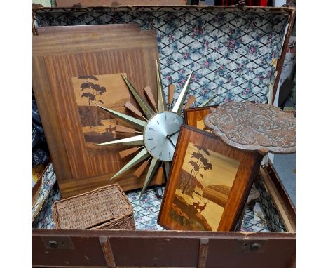 A vintage trunk with wooden strapwork and contents to include a Metamec sunburst wall clock, a carved 2 tier Burmese table in