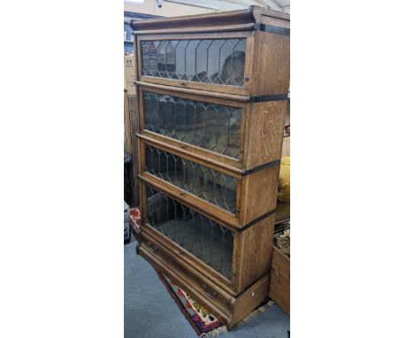 An early 20th century Globe Wernicke oak graduating oak graduating four section bookcase with a drawer below, 147cm h x 87cm 