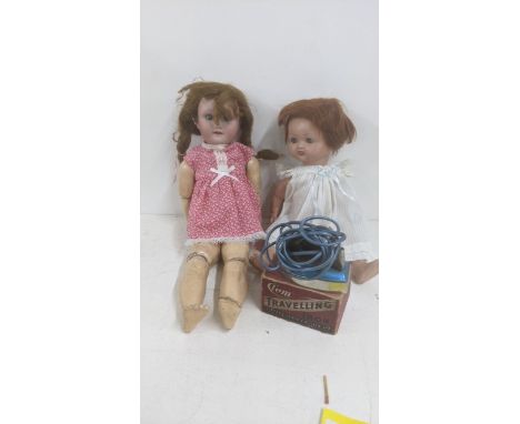 Two dolls to include an early 20th century German bisque head sleeping blue eyes showing two teeth jointed composition, body 
