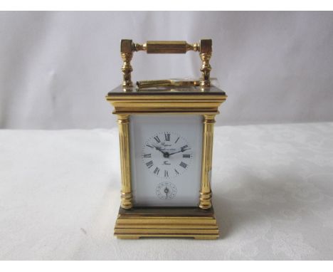 A brass carriage clock striking on a bell to base
