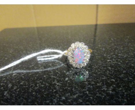 An 18ct Black Opal and Diamond Cluster Ring