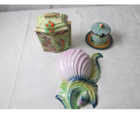 A Carltonware biscuit barrell with hollyhock decoration; together with a wall pocket and preserve pot