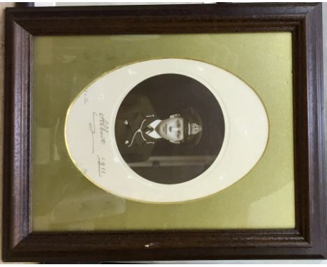 A signed photo of HM King George VI as a midshipman, given to John A W D K Scott when he was a boy at Swaffham, according to 