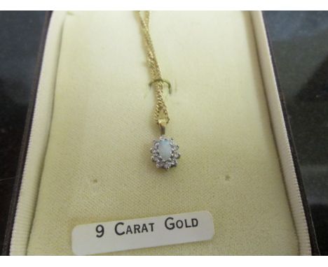 A 9ct chain with opal and diamond pendant