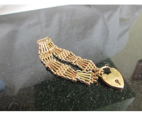 A gold 5 bar gate bracelet