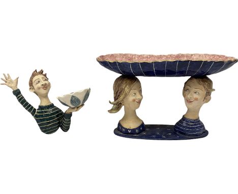Ceramic 'girl and boy dish', by Helen Kemp, an oval dish with a mottled pink ground and gilt edging upon the sculpted heads o