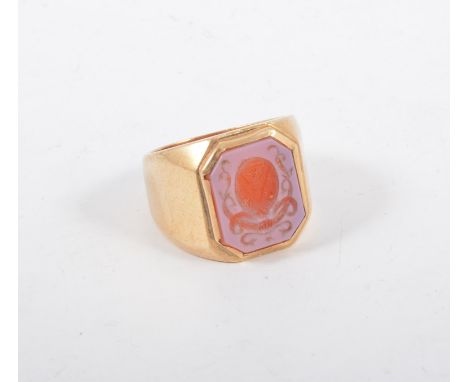 A gentleman's sard onyx signet ring, the intaglio carved rectangular stone 15mm x 11mm with chamfered corners depicting a cre