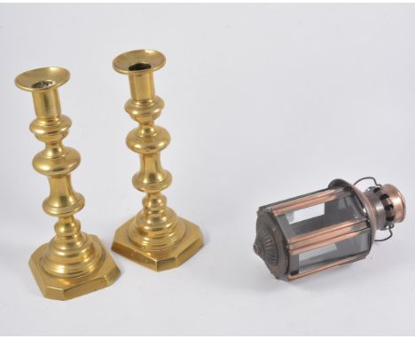 A pair of brass candlesticks, two small copper/metal lanterns, a green enamel Spong mincer (5)