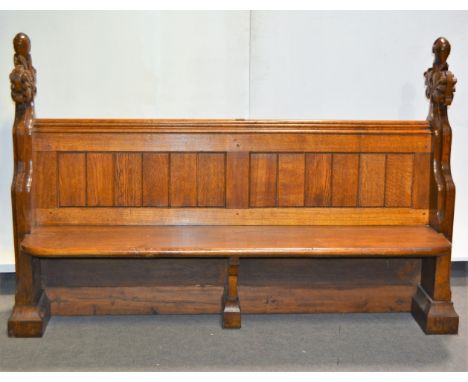 Gothic revival oak pew, standard ends with carved terminals, linen fold panel back, boarded seat, length 173cm, height 115cm.