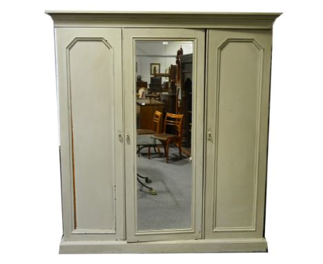 Victorian mahogany triple wardrobe, moulded cornice above central mirrored panel door, flanked by two further panelled doors 