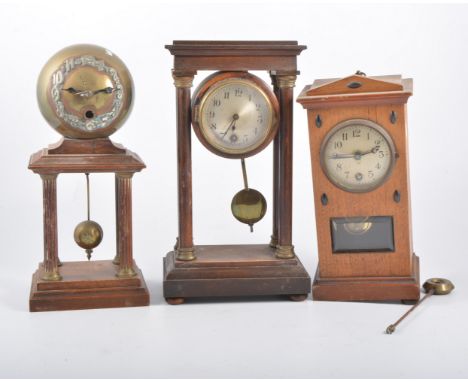 Stained beech Portico clock, 27cm; another Portico clock; and an Edwardian mantel clock. (3)