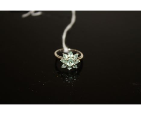 AN 18 CARAT WHITE GOLD GEM SET RING, in a floral style with light green stones, approx weight 4g, ring size N 1/2