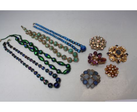 A COLLECTION OF VINTAGE GLASS BEADS ETC., to include foil bead examples, plus a selection of vintage brooches (9)