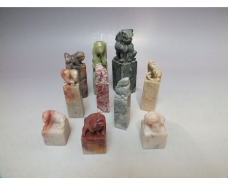 A COLLECTION OF VINTAGE CHINESE CHOPS / SEALS, of varying forms, mainly hardstone examples with carved mythical beasts surmou
