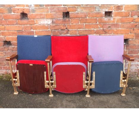 A SET OF THREE VINTAGE FOLD-UP CINEMA SEATS, upholstered in red, blue and purple fabric, W 160 cm