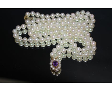 A SET OF CULTURED PEARL WITH HALLMARKED 9 CARAT GOLD AMETHYST AND PEARL CENTRAL DROPPERCondition Report:Part of clasp missing