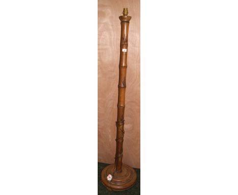 A teak standard lamp in the guise of a carved bamboo column raised on a stepped circular base CONDITION REPORT; Approximately