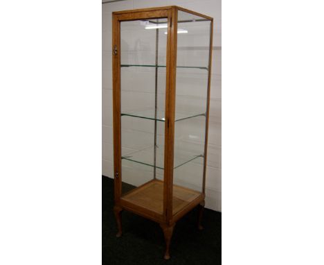 An oak framed glazed shop cabinet, with four display sides, hinged single door and three glass shelves CONDITION REPORT; Appr