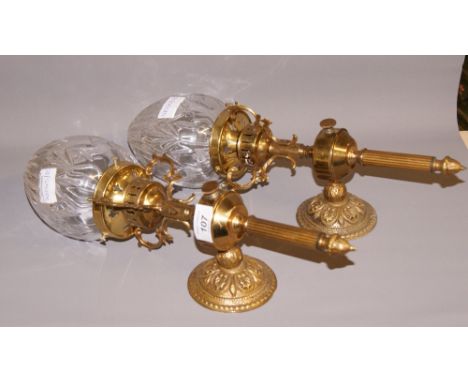 A pair of brass wall mounting electric light fittings with cut glass shades  CONDITION REPORT; Approximately 43 cm tall. Work