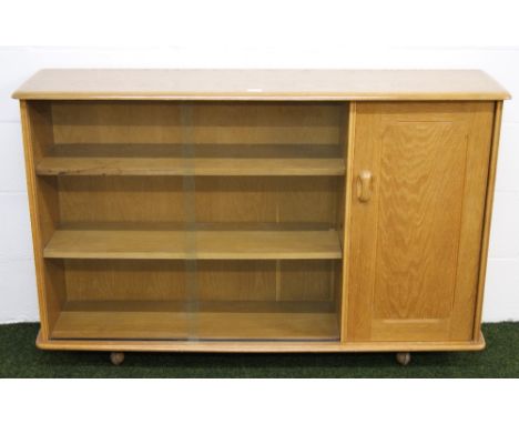 An Ercol style elm bookcase, with two glass panel doors and a solid doors CONDITION REPORT; Approximately 87 cm in height x 1