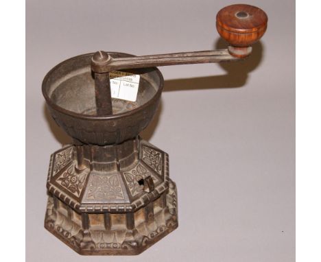 Pagoda style cast metal coffee grinder CONDITION REPORT; Approximately 20 cm tall
Articulate top lifts to expose the tin insi