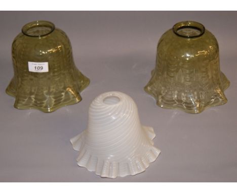 A pair of green translucent glass light shades and a milk glass translucent light shade CONDITION REPORT; Tallest approximate
