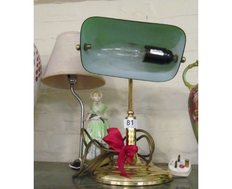 A desk light with green shade and a lamp with lady to base
