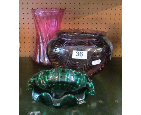 A heavy swirl pattern amethyst glass vase and two other coloured glass items