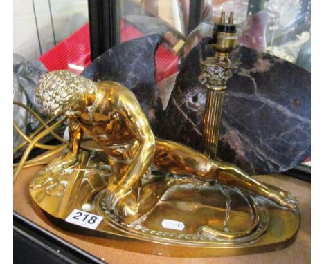 A heavy brass lamp nude man lying with sword and ribbon (marble base a/f)