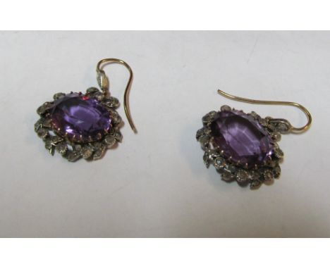 A pair of amethyst and diamond earrings