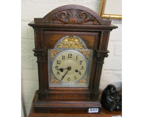 An Edwardian oak cased mantel clock