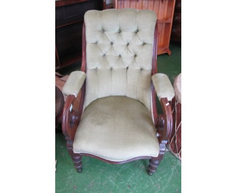 A Victorian button upholstered chair with scroll arms on turned feet