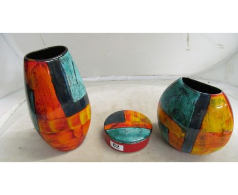 A Poole Pottery tall 'Jewel' vase, similar squat vases and a lidded dish