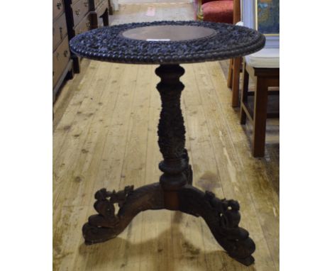 A Burmese carved wood tripod table, 64 cm wide 