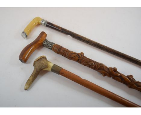 A holly walking stick, profusely carved acorns, oak leaves and a serpent, 90 cm long and two other walking sticks (3) Conditi