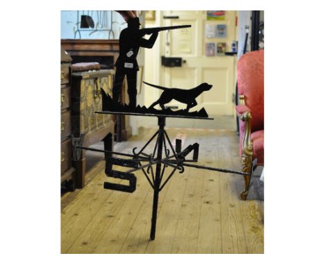 A black painted weather vane, with a shooting figure in the centre