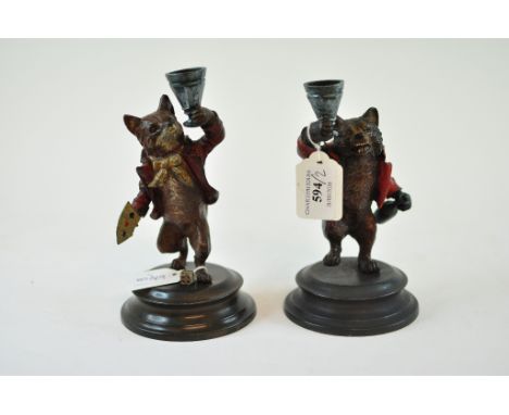 A figural painted metal candlestick, in the form of a bear, 17 cm high, and another, in the form of a fox (2)