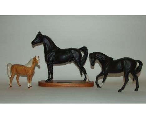 A Beswick Connoisseur Morgan Stallion, 2605 (ear chipped), a Black Beauty, 2466, and Spirit of Freedom, white on a black plin