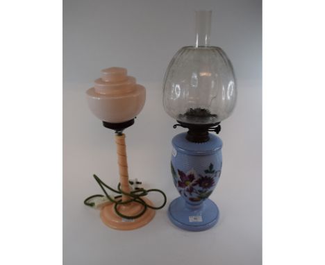 A light blue glass table oil lamp, with painted floral decoration and an etched shade, 58 cm high, and a mid 20th century tab